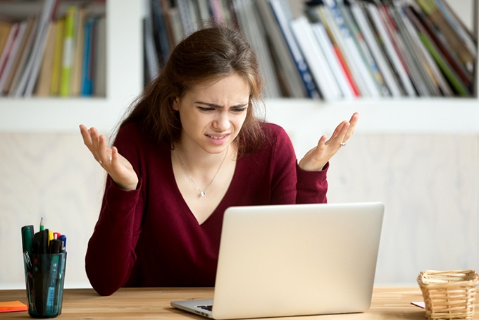 Coursera Python: woman confused and irritated looking at a computer screen.